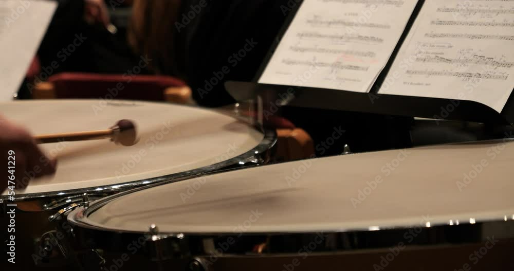 Poster close up shot of a drummer with a timpani during a concert with orchestra to classical music for the