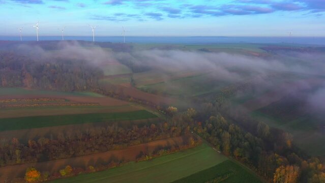 Autumn Season In Rural Landscape With Wind Turbines During Foggy Day. Aerial Drone Shot
