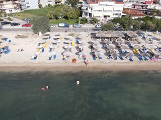 Aerial drone view plataria greece, beach crowded with tourists in vacation on summer in famous...