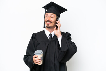 Young university graduate man isolated on white background holding coffee to take away and a mobile