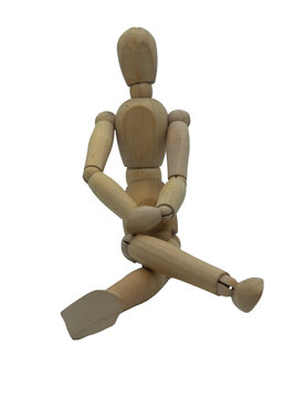 Wooden jointed figure sitting on ground with legs crossed and hands on lap