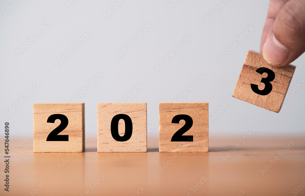 Poster hand assemble 2023 on wooden block cube for preparation new year change and start new business targe