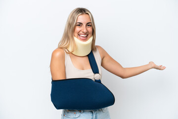 Woman with broken arm and wearing a sling isolated on white background extending hands to the side...