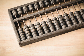 Chinese traditional calculator, old abacus on wooden backgroun