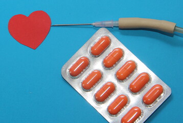 treatment of cardiac diseases, tablets in a blister on a blue background