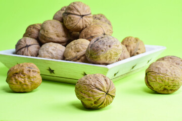 Walnut, full of properties, source of proteins, very healthy. Green background..