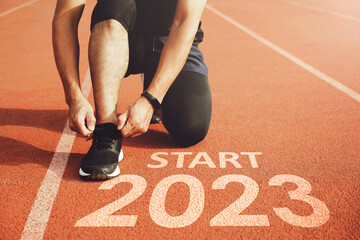 happy new year 2023,2023 symbolizes the start of the new year. Start with a man preparing to run on...