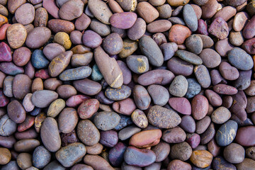 small smooth waterworn black pebbles or stones for use decor and garden landscaping. tone garden interiors. stone spa