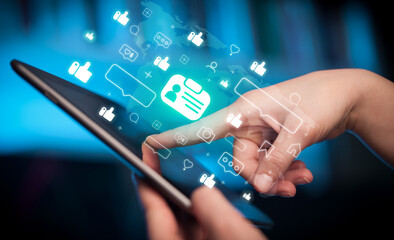 Close-up of a hand using tablet, social media concept