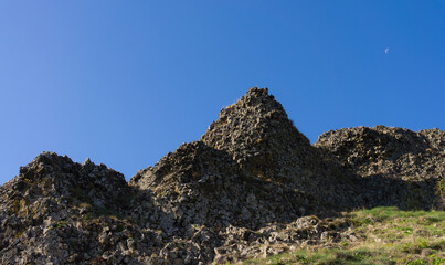 The volcanic rocks above the village of Ajoux near 07000 Privas France in the Ardeche at rising moon