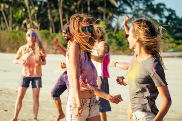 multinational multicultural mixed race friends in holi dust on beach in Goa