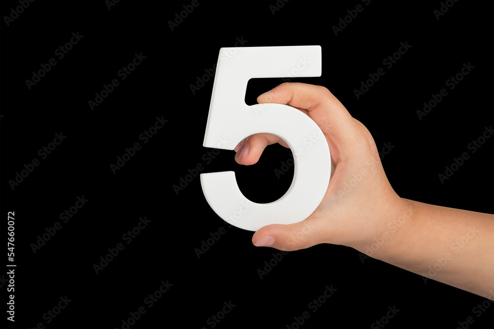 Poster Number five in hand isolated on black background. Number five in the hand of a child holding on a black background. To be inserted into a project or design.