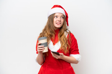 Young caucasian woman with Christmas dress isolated on white background holding coffee to take away and a mobile while thinking something