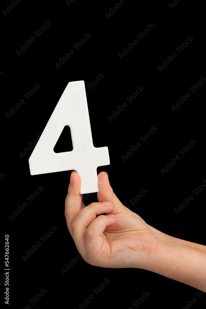 Poster Number four in hand isolated on black background. Number four in a child's hand, holding on a black background. To be inserted into a project or design.