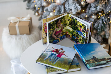 Naklejka na ściany i meble a photo album near the Christmas tree as a gift
