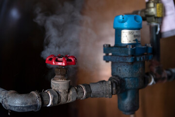 Machinery close up - valve releasing steam