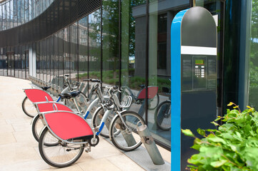 Payment terminal near parking lot with many bicycles outdoors - obrazy, fototapety, plakaty