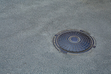 Metal sewer hatch on asphalt outdoors, space for text