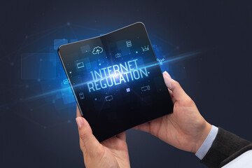 Businessman holding a foldable smartphone, security concept