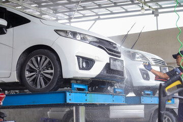 Wash the car at the car wash.  Car wash with foam and high pressure water.  car wash with hydraulic system