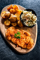 Chicken cutlet coated with breadcrumbs with potatoes and cabbage