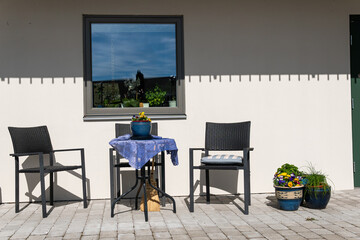 Little table and chairs on the veranda on a sunny day, relaxing zone. Cozy and comfortable atmosphere.