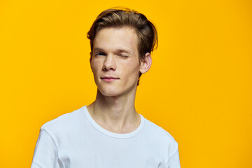 portrait of a cute, winking guy in a white t-shirt