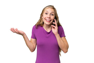 Young blonde woman over isolated background keeping a conversation with the mobile phone with someone