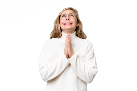 Young blonde woman over isolated background keeps palm together. Person asks for something