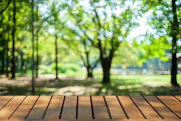 wooden table with park bokeh background