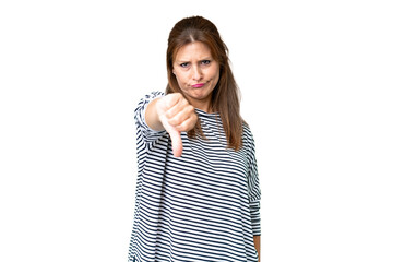 Middle age woman over isolated background showing thumb down with negative expression