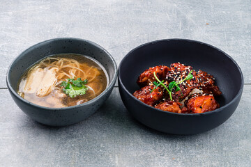 Lunch ramen broth with noodles and chicken and fried chicken in soy sauce.