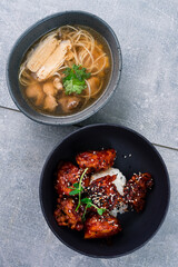 Lunch chicken broth with noodles and fried chicken in soy sauce.