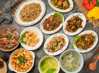 Assorted Shrimp, Sausage and Egg Fried Rice, Mabo tofu, Pineapple Shrimp Balls, large intestine bowl, egg drop soup, Kung Pao Beef, Fish Soup and diced chicken isolated table top view of chinese food