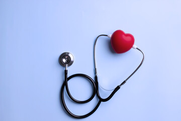 Flat lay of stethoscope is listening red heartbeat for checkup. Heart attack prevention. Health care concept.
