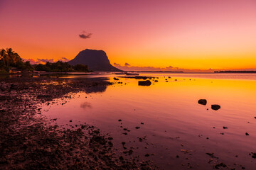 Fototapeta premium Ocean at low tide and colorful sunset time. Le Morn mountain in Mauritius.