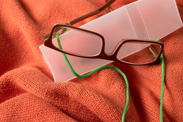 Glasses. Plastic case with glasses on an orange fabric