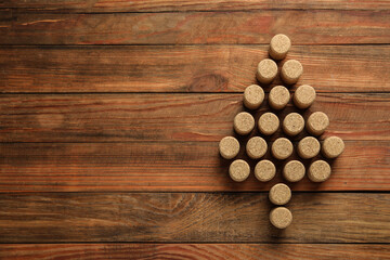 Christmas tree made of wine corks on wooden table, top view. Space for text