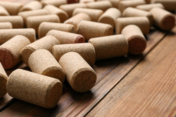 Many corks of wine bottles on wooden table, closeup