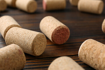 Many corks of wine bottles on wooden table, closeup