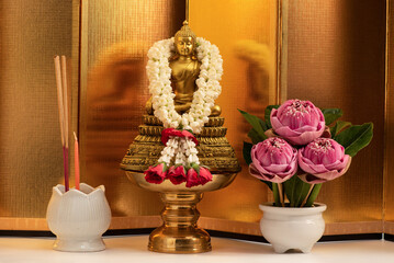 Pink lotus and buddha on golden background.