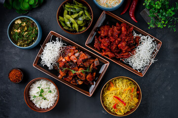 Asian lunch pork with shiitake mushrooms and vegetables, sweet and sour chicken, rice noodles with sweet pepper, beans, homemade cheese with spinach and spices.