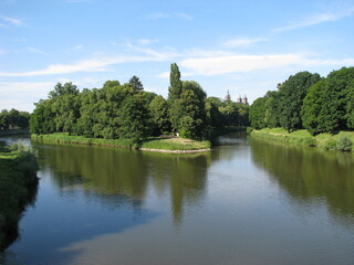 Confluence of two rivers in the city with a church in the background