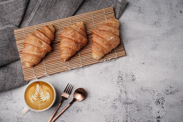Morning aromatic coffee served with sweet croissants on top view white background, coppy space.