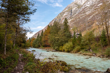 Fototapeta na wymiar The Soca river flowing through a wild mountain landscape of the Julian Alps in Slovenia
