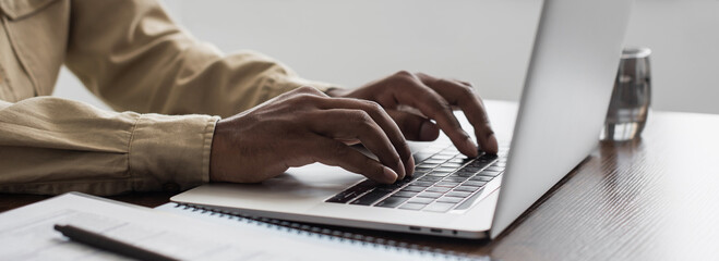 Man hands typing on computer keyboard closeup panoramic banner, businessman or student using laptop at home, online learning, internet marketing, working from home, office workplace, freelance concept