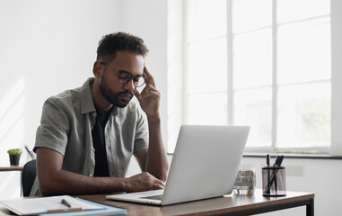 Stressed man professional sitting at office workplace, Tired and overworked businessman, Young...