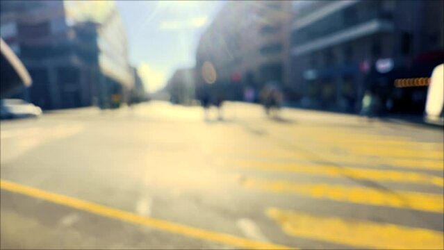 Blurred pedestrian walking down the city street and moving cars. Crowd of people in bokeh lights. Blurred background. People walk in city square