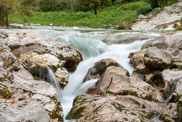 The Soca river flowing through a wild mountain landscape of the Julian Alps in Slovenia