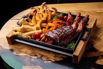 Shrimp platter in batter, fish and chips, rustic potatoes, ribs and wings in BBQ sauce